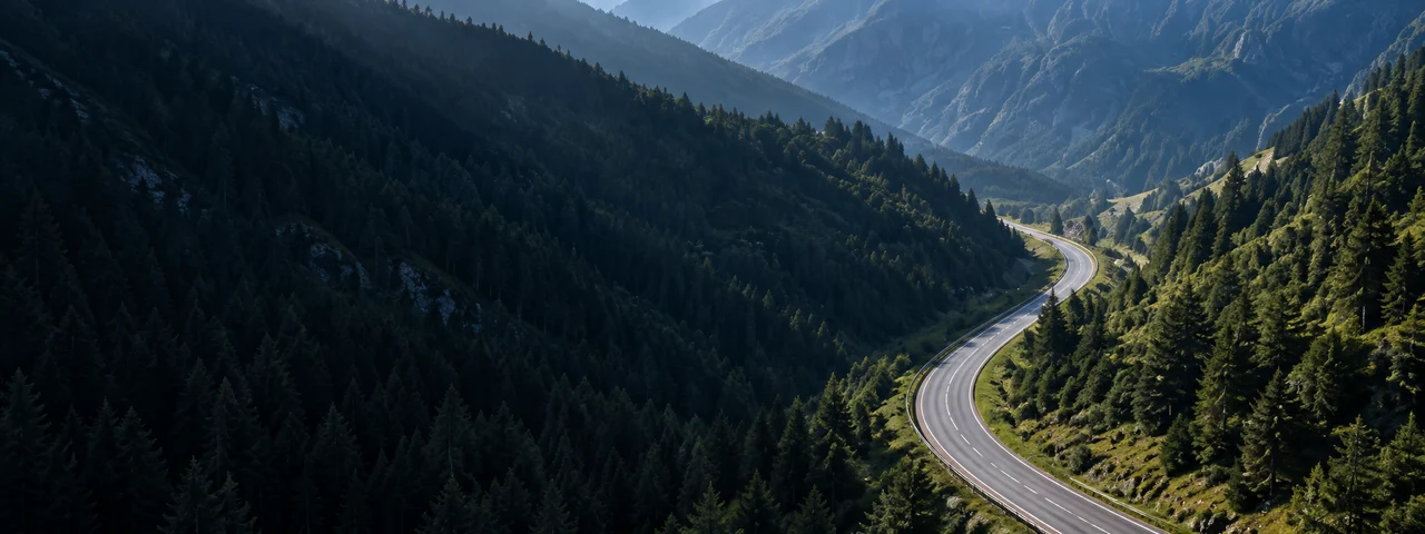 A winding road through a green Alpine valley